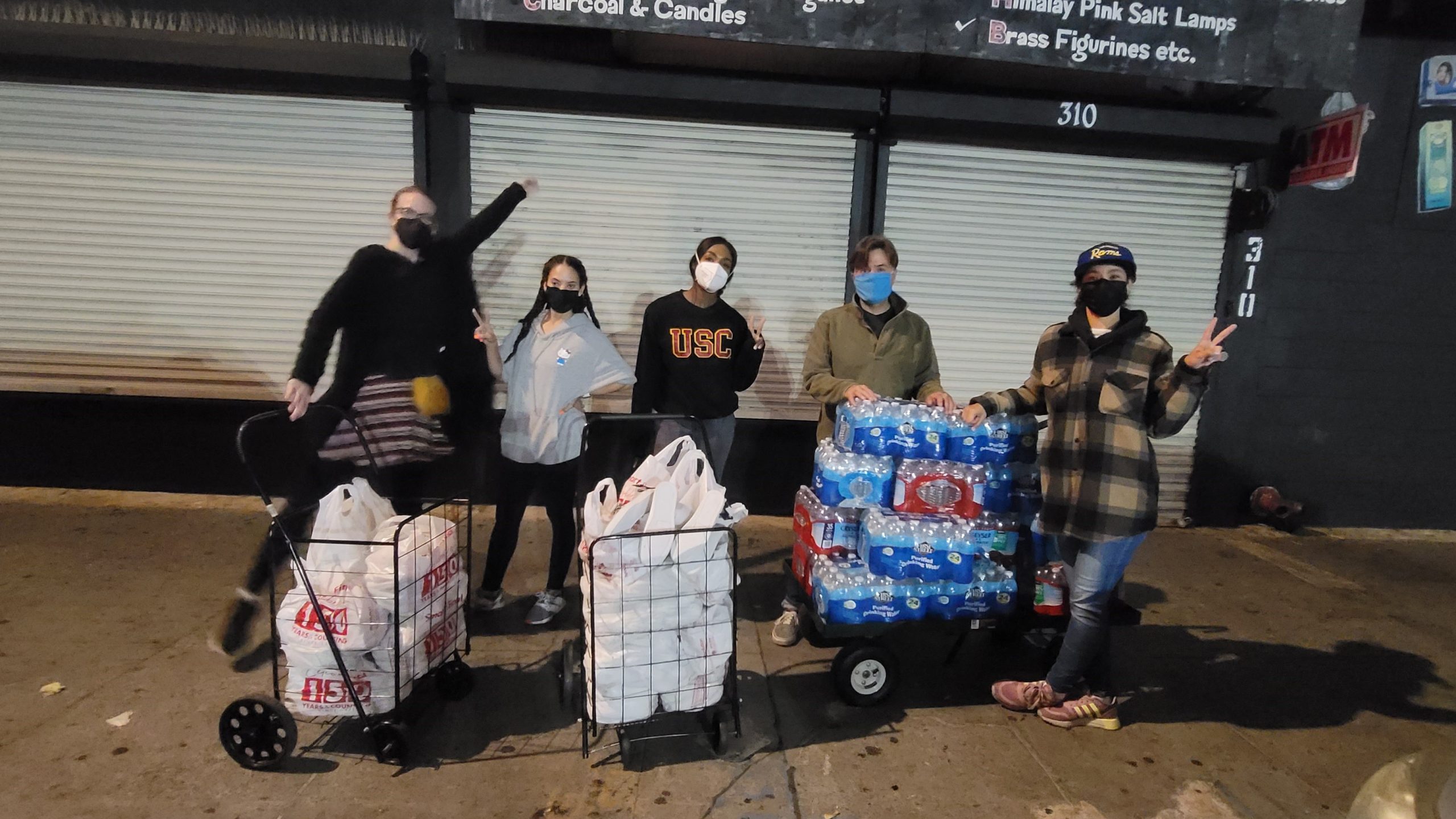 Volunteers with carts of bottled water for delivery on Skid Row
